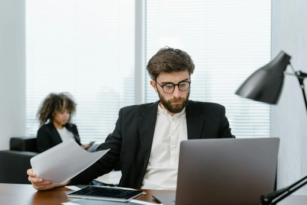 Professional business consultant reviewing branding strategy documents at modern office desk