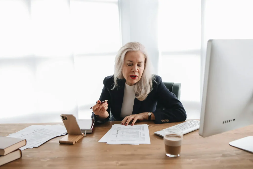 Professional businesswoman reviewing change management documents at modern office desk