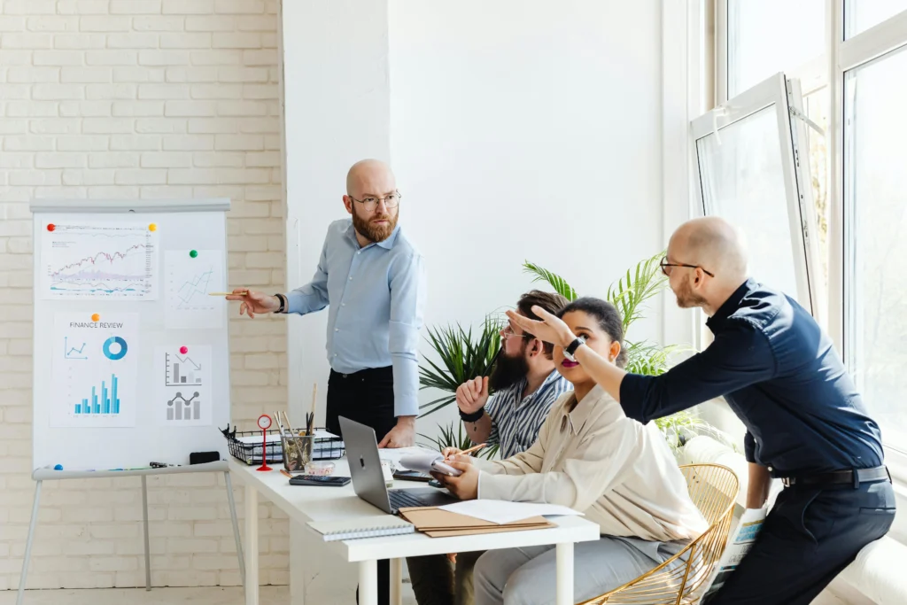 Business support through financial analysis presentation and strategic consulting collaboration in modern office setting