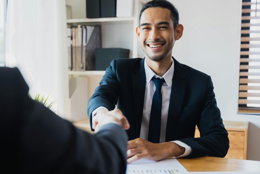 Professional ethics training facilitator shaking hands with employee in Canadian workplace ethics education program