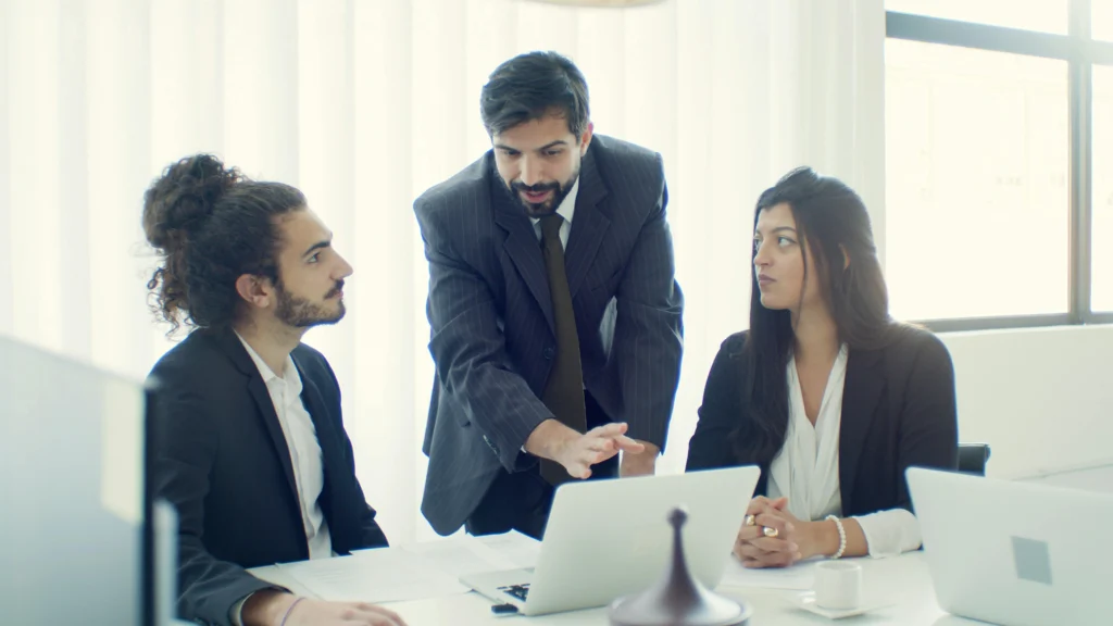 Business professionals discussing financial modeling and expense control systems.