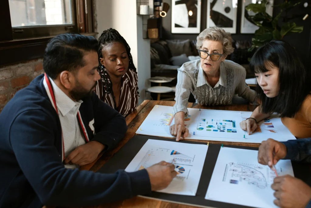 Diverse team of lead generation specialists analyzing conversion optimization strategies and funnel reports