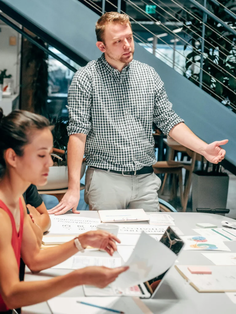 PPC advertising consultant presenting paid campaign strategies to client in modern Canadian office