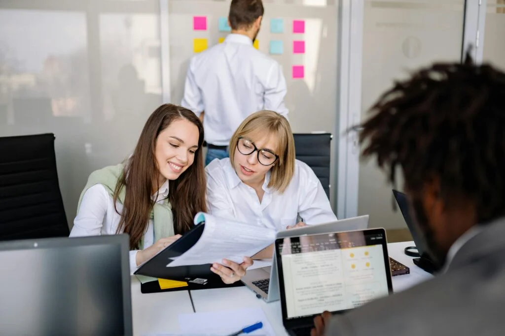 Team collaborating on project management strategies in a Canadian office.