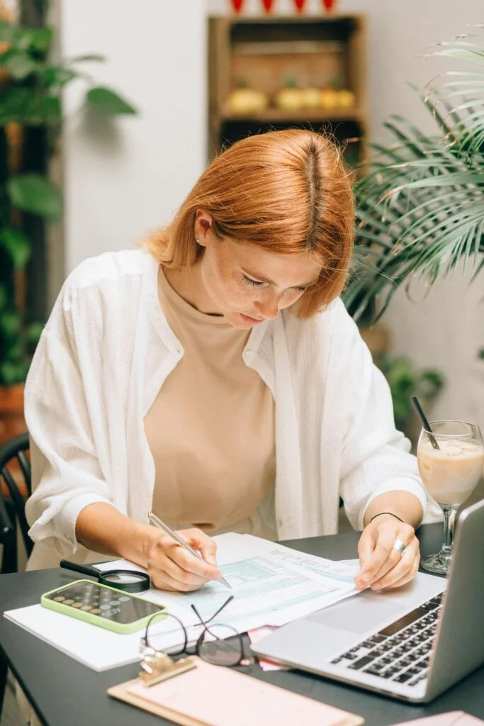 Professional woman analyzing SEO data and organic traffic reports on laptop in modern office setting