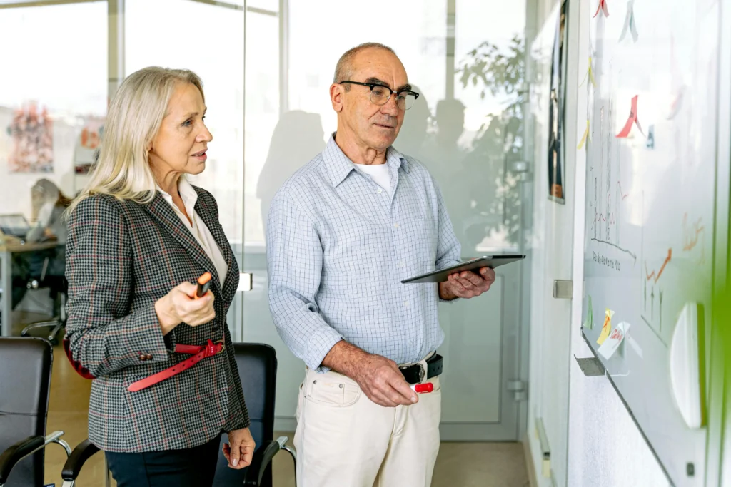 Pearl Lemon Consulting Canada workforce efficiency consultants analyzing performance metrics and oversight data on glass board in modern office